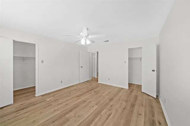 a view of a room with wooden floor