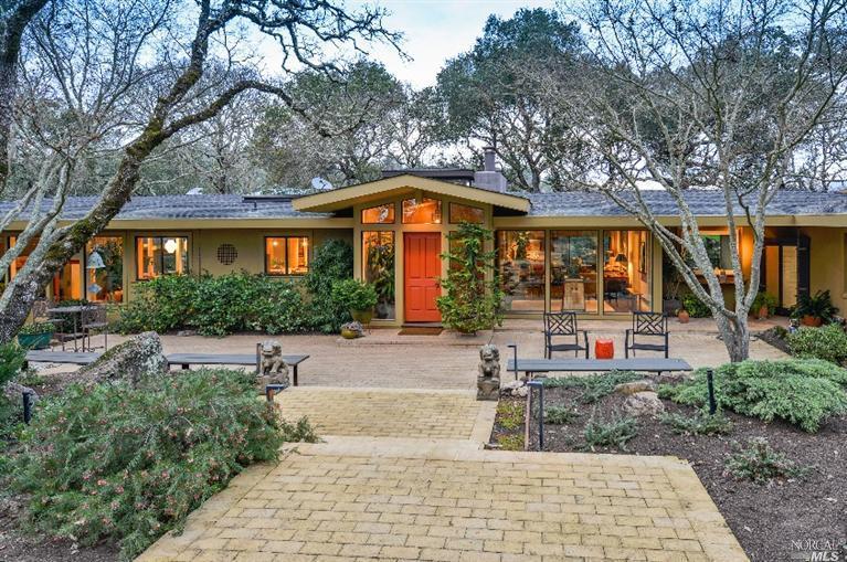 a front view of house with yard and green space