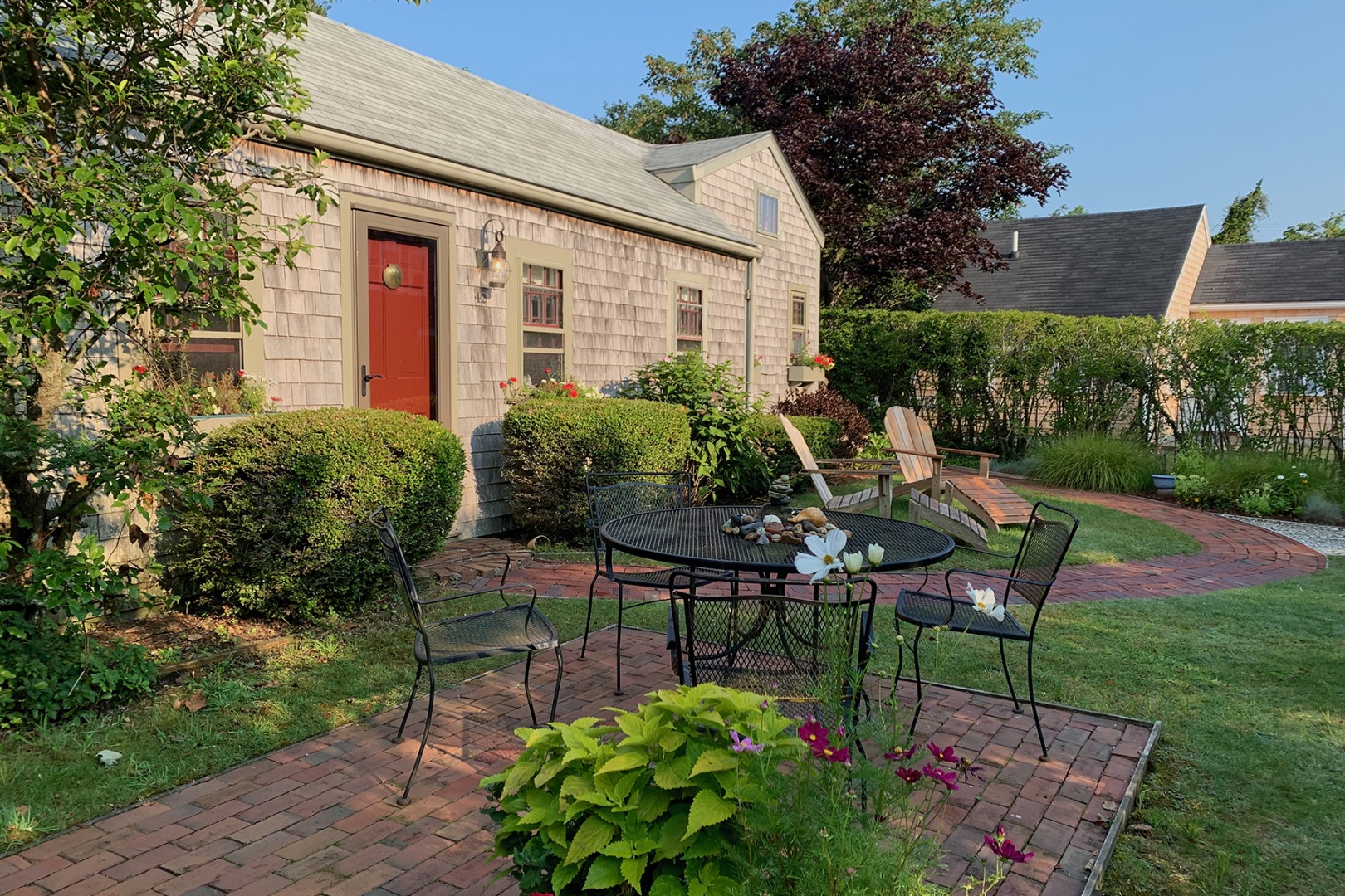 42 North Liberty Street Nantucket, MA 02554 - Photo 2 of 20 a view of a chairs and table in backyard of the house