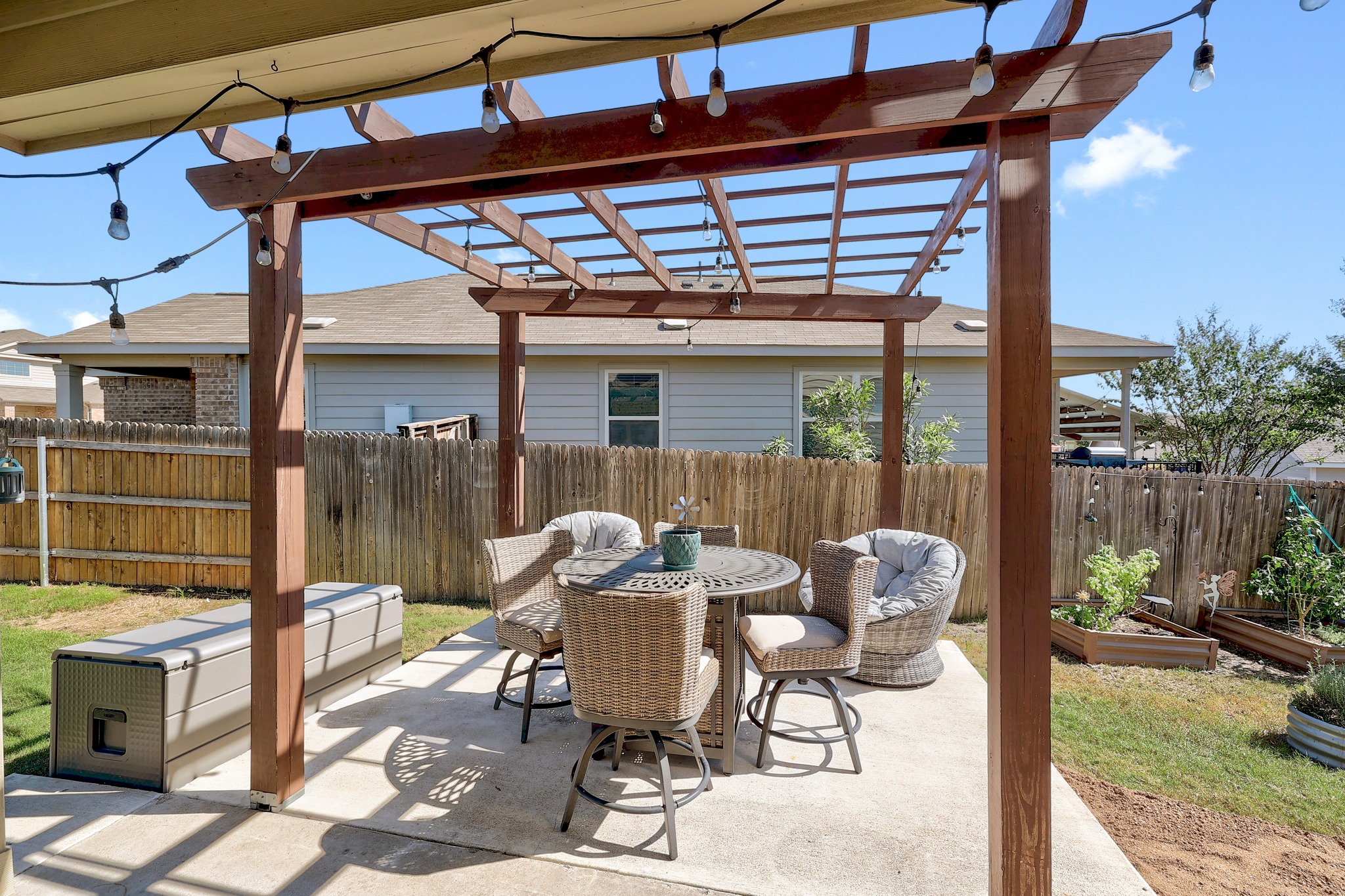 735 Circle Way Jarrell, TX 76537 - Photo 24 of 32 A sturdy wooden pergola shades a concrete patio within a fully fenced backyard.