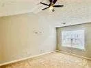 an empty room with a empty space and windows