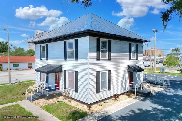 a view of a house with a yard porch and furniture