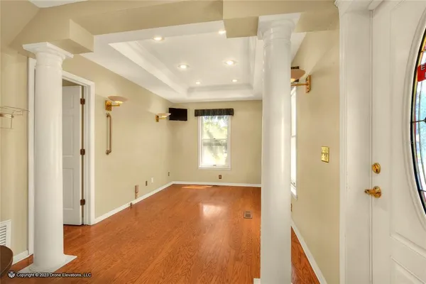 a view of a hallway with wooden floor and staircase
