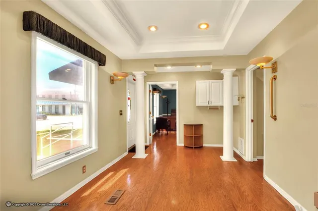 a kitchen with stainless steel appliances a refrigerator a stove a dining table and chairs