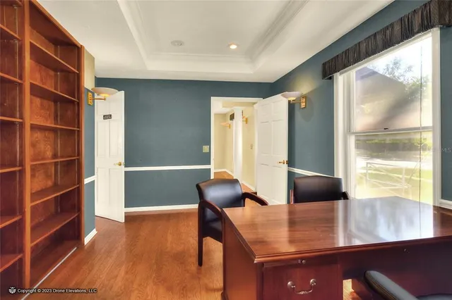 a view of a room with furniture and wooden floor