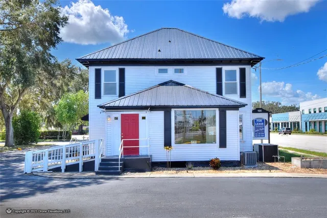 a living room with furniture and floor to ceiling windows
