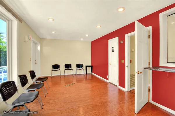 a view of a room with wooden floor and furniture