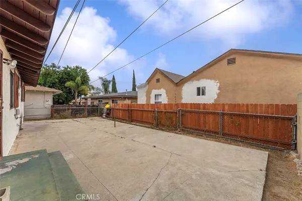 a view of a house with a wooden fence