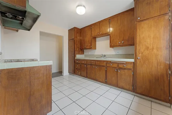 a kitchen with stainless steel appliances a refrigerator sink and cabinets