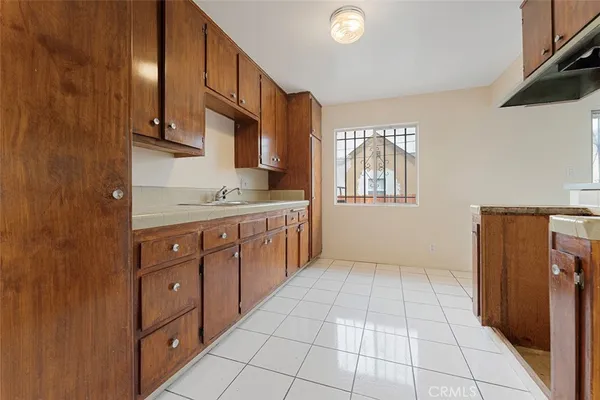 a spacious bathroom with a granite countertop sink a mirror and a shower