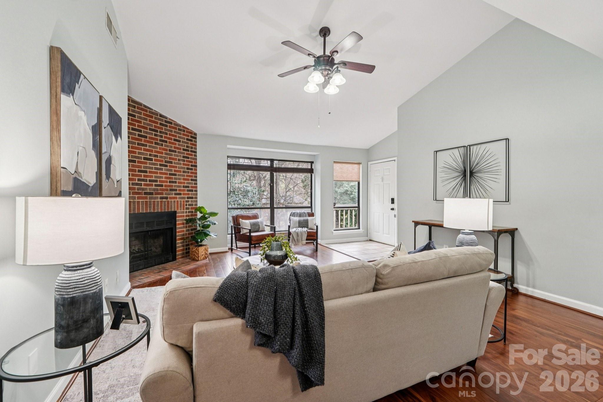 1606 Sharon Road West, Unit 40 Charlotte, NC 28210 - Photo 12 of 28 a living room with furniture a fireplace and a large window