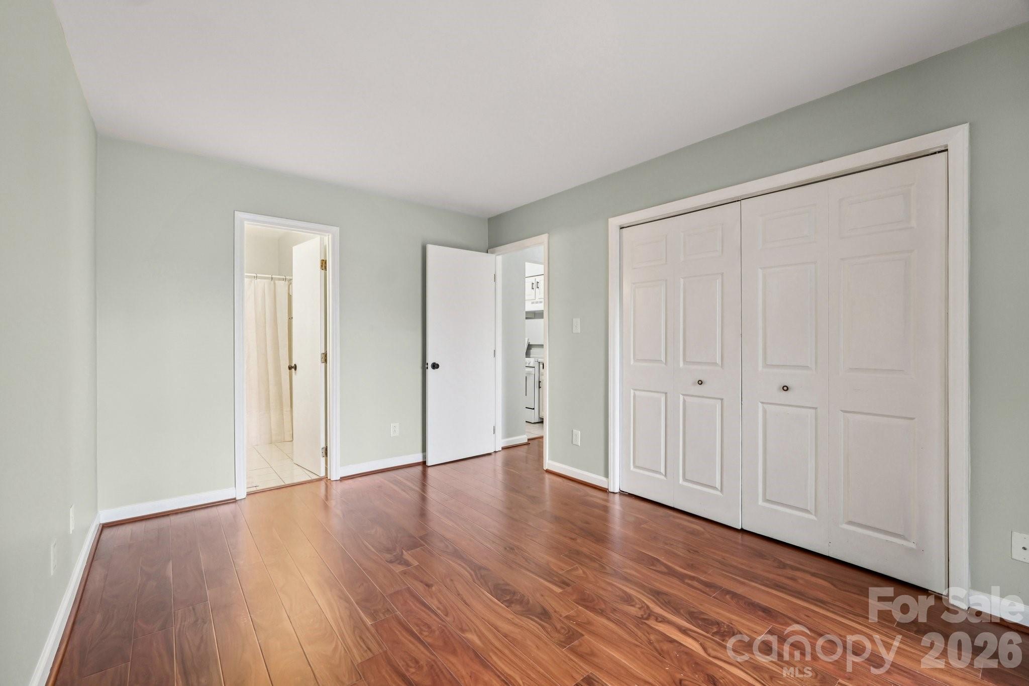 1606 Sharon Road West, Unit 40 Charlotte, NC 28210 - Photo 20 of 28 a view of an empty room with wooden floor