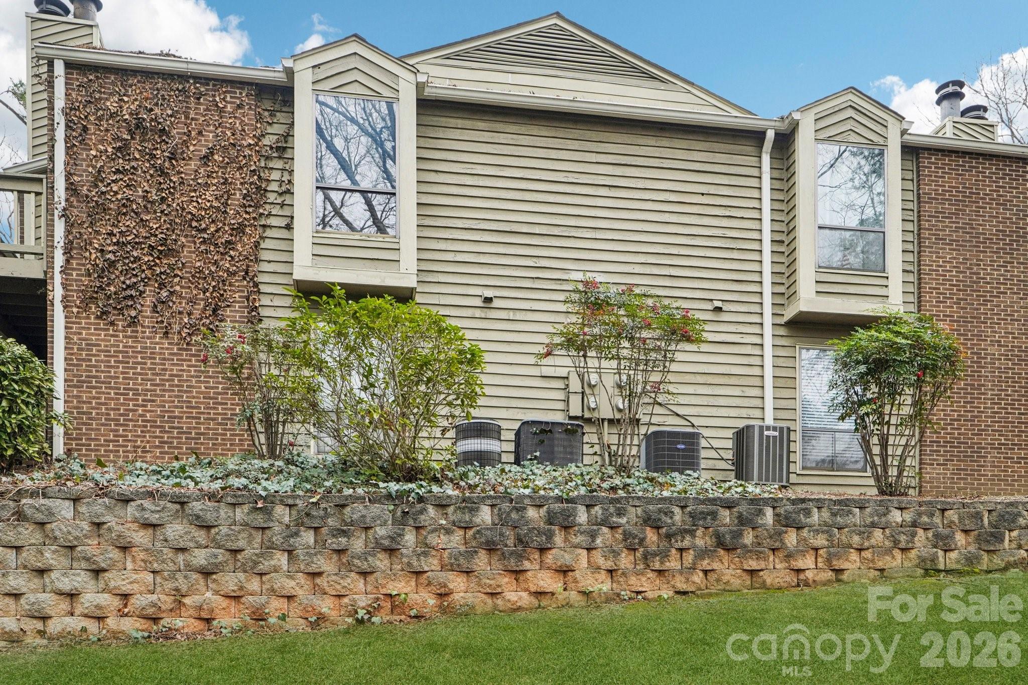 1606 Sharon Road West, Unit 40 Charlotte, NC 28210 - Photo 23 of 28 a front view of a house with garden