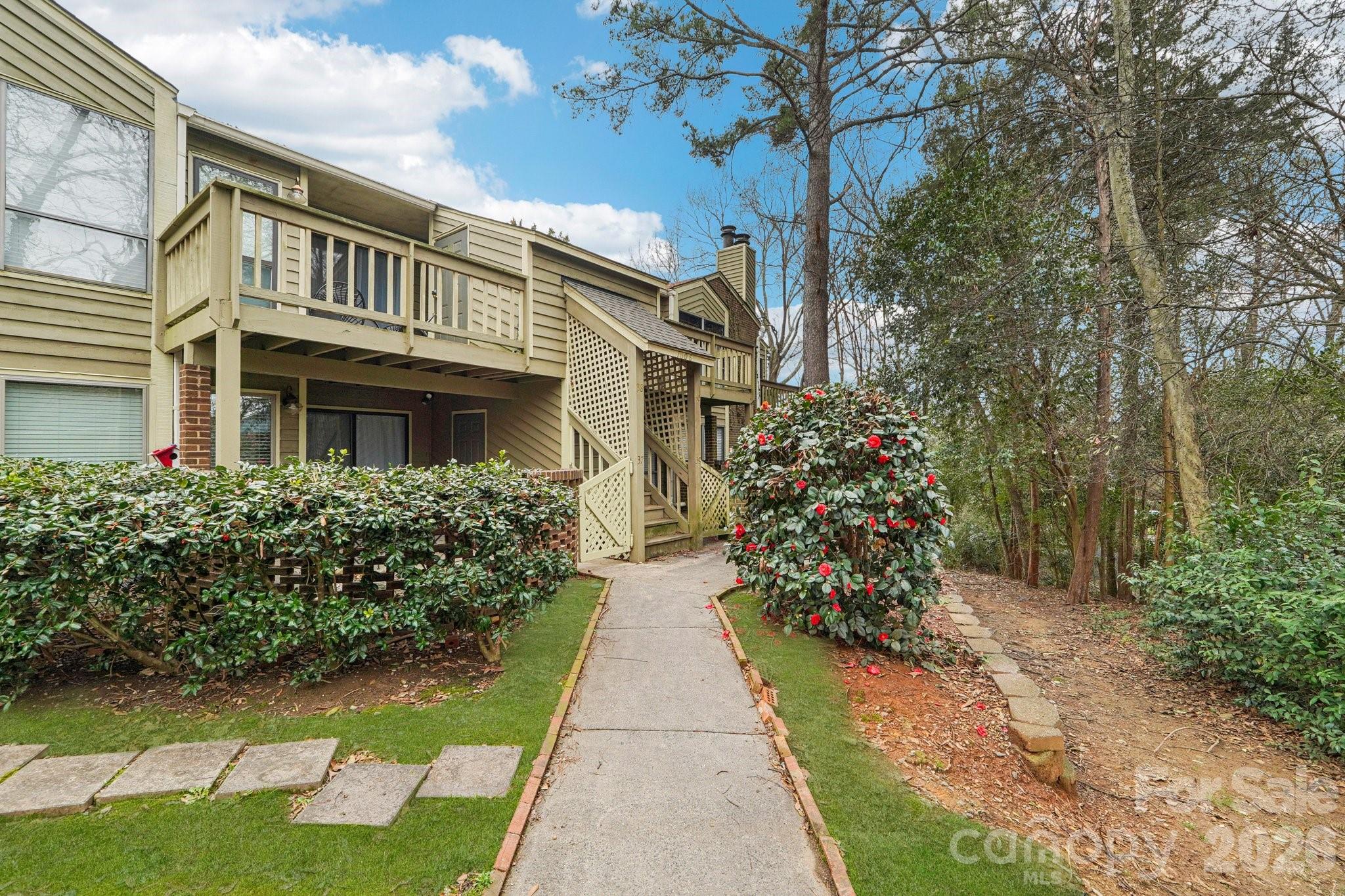 1606 Sharon Road West, Unit 40 Charlotte, NC 28210 - Photo 3 of 28 a view of a pathway with a yard