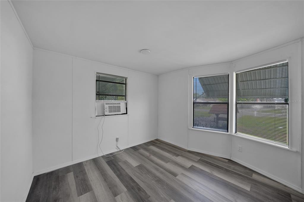 1298 Southeast Lake Road Arcadia, FL 34266 - Photo 12 of 35 a view of empty room with wooden floor and fan