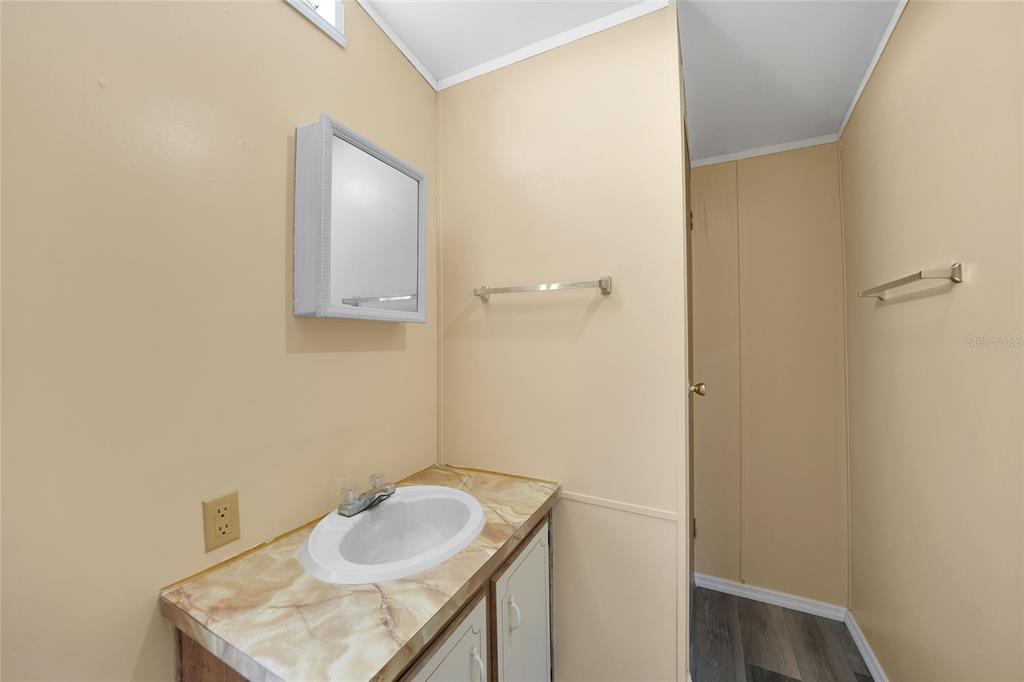 1298 Southeast Lake Road Arcadia, FL 34266 - Photo 21 of 35 a bathroom with a sink and mirror