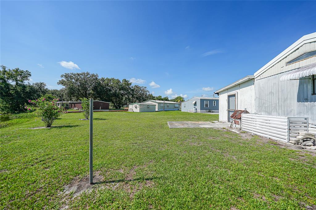 1298 Southeast Lake Road Arcadia, FL 34266 - Photo 31 of 35 a backyard of a house with table and chairs