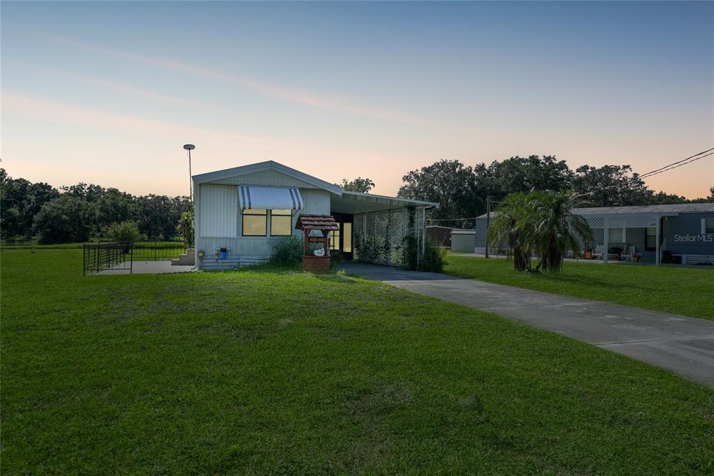 1298 Southeast Lake Road Arcadia, FL 34266 - Photo 35 of 35 a front view of a house with garden