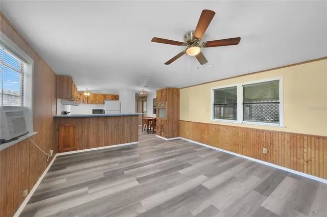 a view of empty room with wooden floor and window