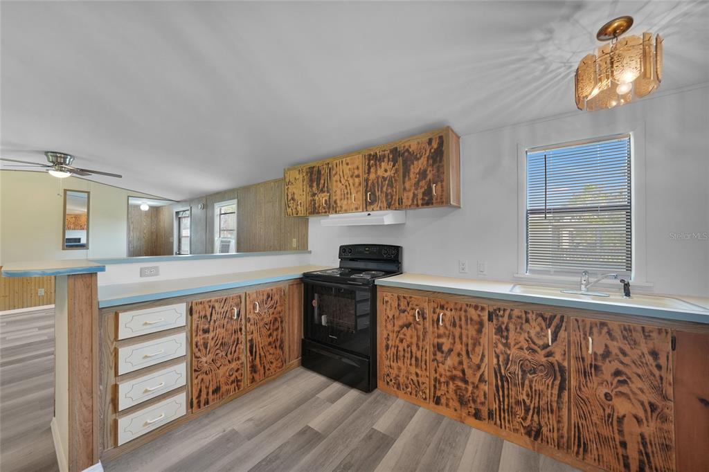 1298 Southeast Lake Road Arcadia, FL 34266 - Photo 7 of 35 a kitchen with stainless steel appliances granite countertop a stove and a wooden floors