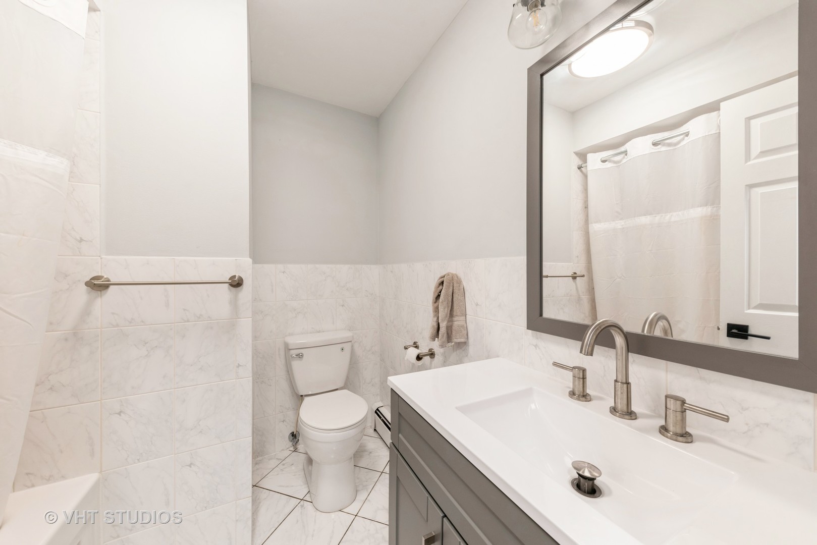 2214 South Goebbert Road, Unit 478 Arlington Heights, IL 60005 - Photo 11 of 14 a bathroom with a sink toilet and shower