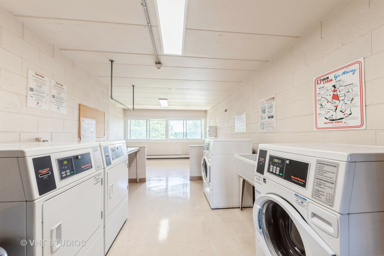 2214 South Goebbert Road, Unit 478 Arlington Heights, IL 60005 - Photo 12 of 14 a view of washer and dryer with kitchen in the background