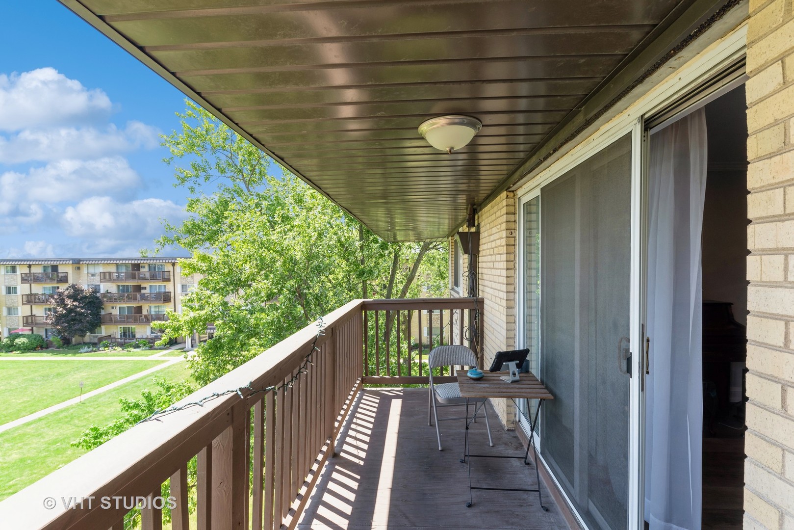 2214 South Goebbert Road, Unit 478 Arlington Heights, IL 60005 - Photo 13 of 14 a view of balcony with wooden floor and fence