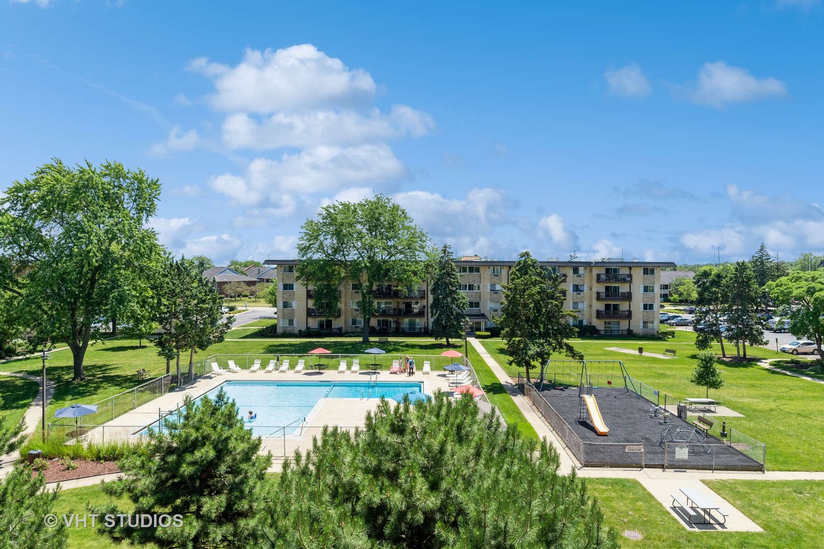 2214 South Goebbert Road, Unit 478 Arlington Heights, IL 60005 - Photo 14 of 14 a view of a swimming pool with a yard and plants