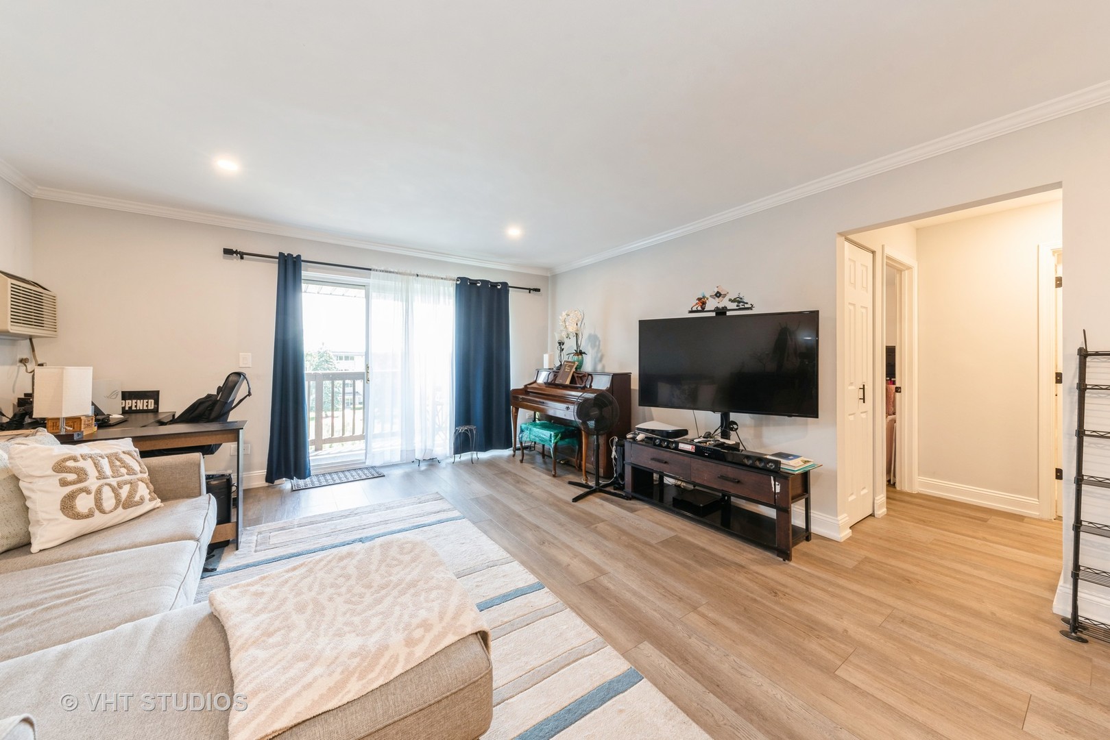 2214 South Goebbert Road, Unit 478 Arlington Heights, IL 60005 - Photo 2 of 14 a living room with furniture and a flat screen tv