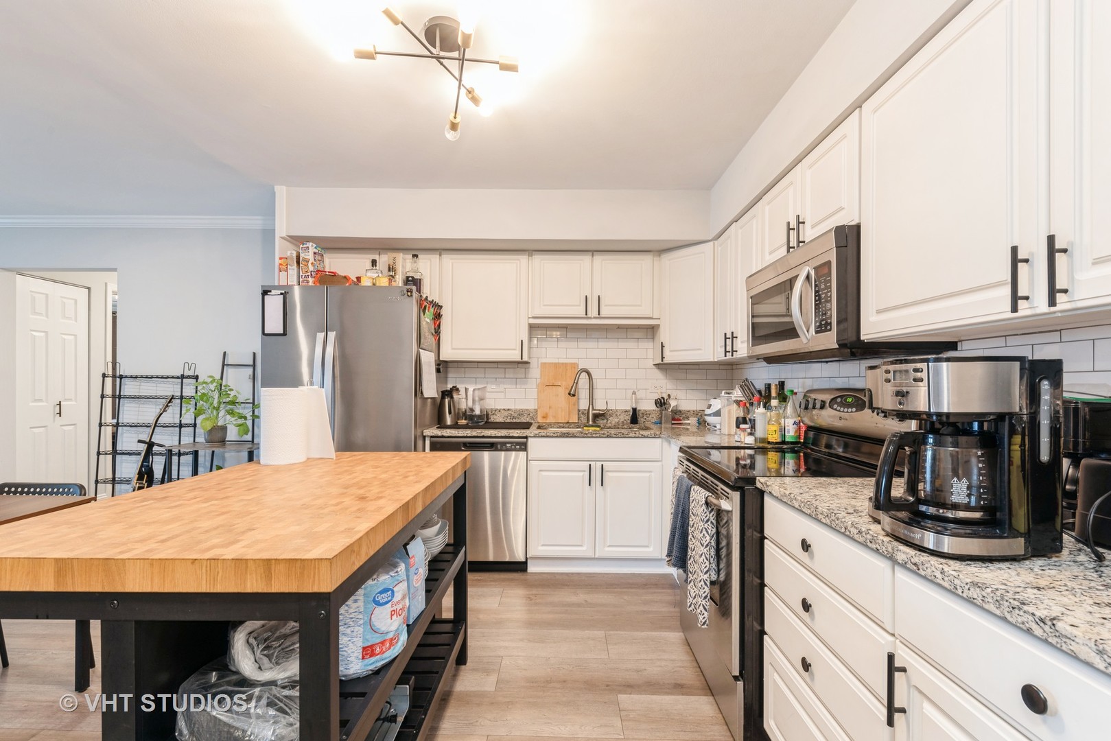 2214 South Goebbert Road, Unit 478 Arlington Heights, IL 60005 - Photo 4 of 14 a kitchen with stainless steel appliances granite countertop a sink a stove and refrigerator