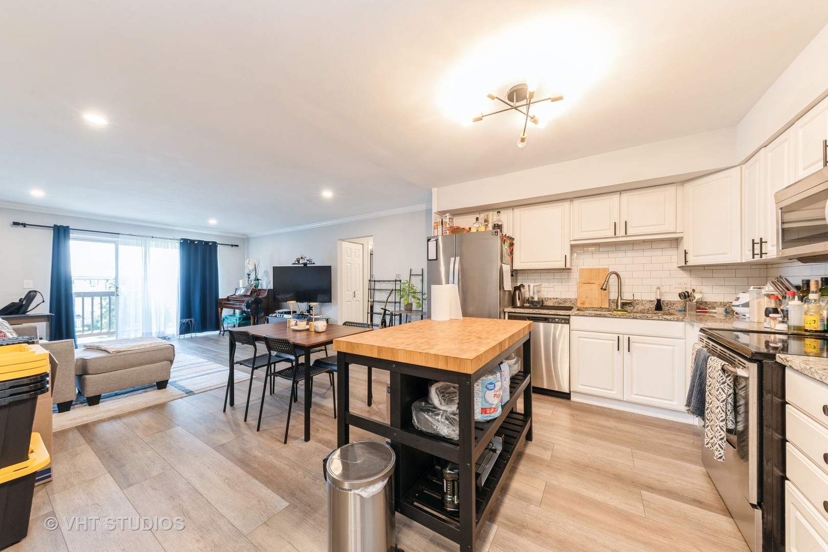 2214 South Goebbert Road, Unit 478 Arlington Heights, IL 60005 - Photo 5 of 14 a open kitchen with stainless steel appliances granite countertop a stove top oven a sink dishwasher and white cabinets with wooden floor