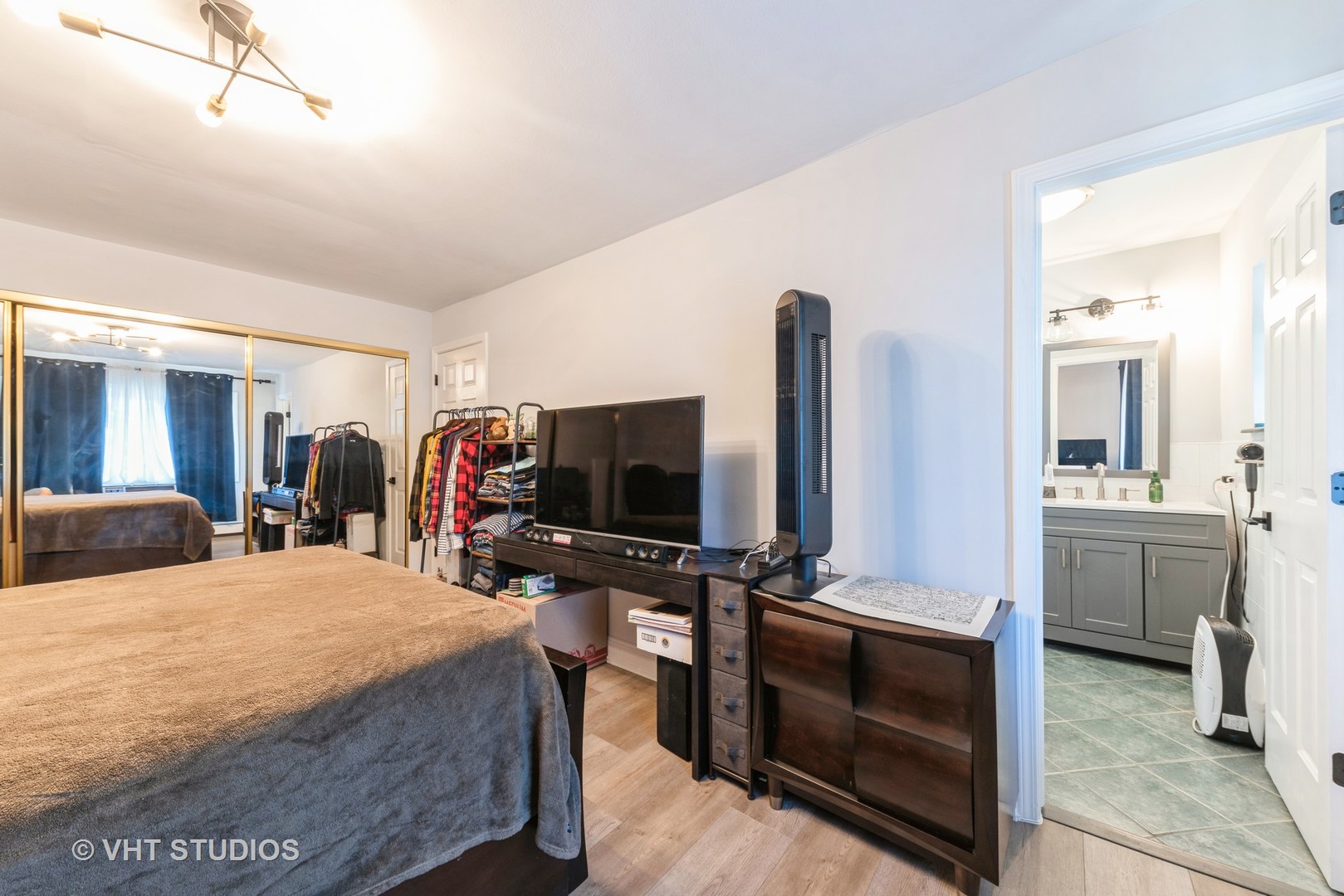 2214 South Goebbert Road, Unit 478 Arlington Heights, IL 60005 - Photo 8 of 14 a bedroom with a bed and a flat screen tv