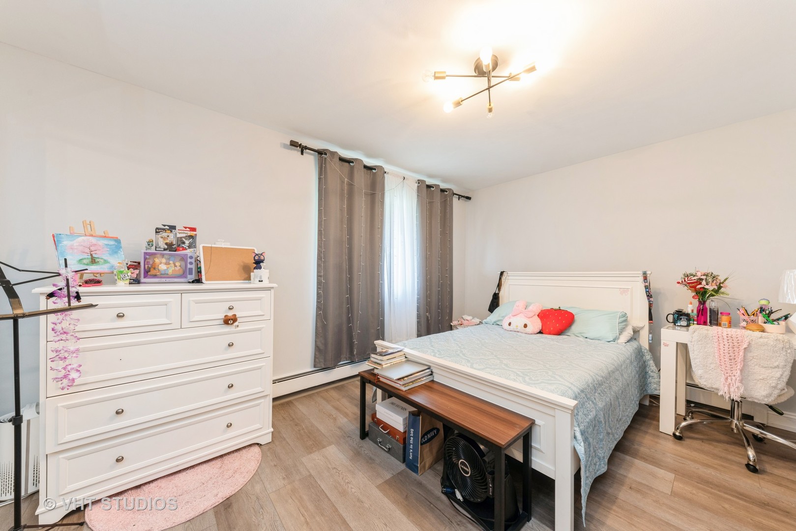 2214 South Goebbert Road, Unit 478 Arlington Heights, IL 60005 - Photo 10 of 14 a bedroom with a bed and a chandelier