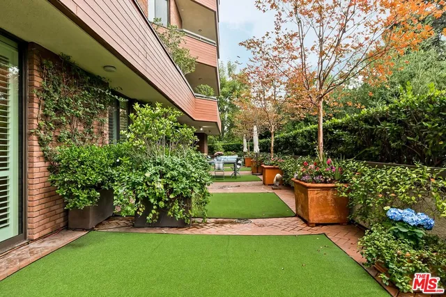 a view of a chair and table in backyard of the house