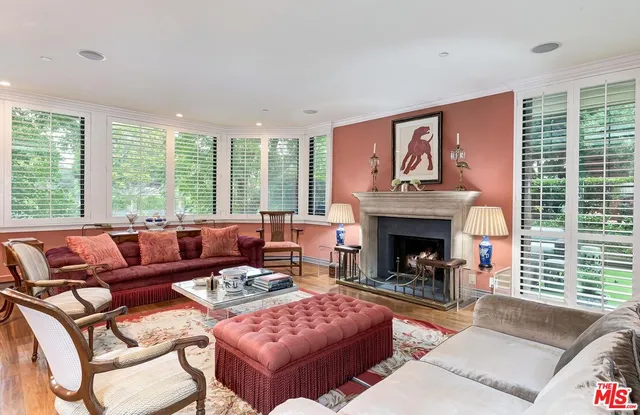 a living room with furniture large window and a fireplace