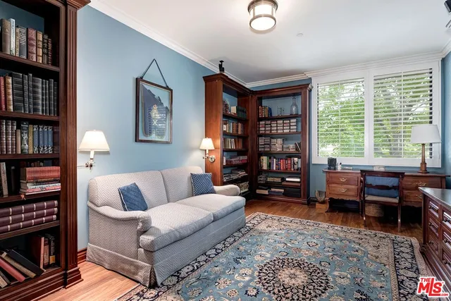 a living room with furniture and a bookshelf