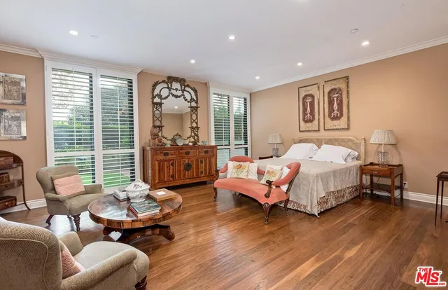 a bedroom with bed and wooden floor