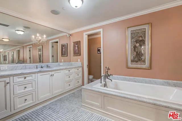 a spacious bathroom with a granite countertop sink mirror and bathtub