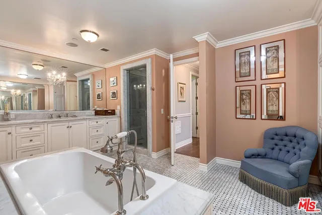 a bathroom with a tub sink shower and mirror