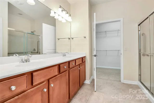 a bathroom with a glass shower door