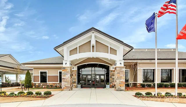 a view of a swimming pool and lounge chairs