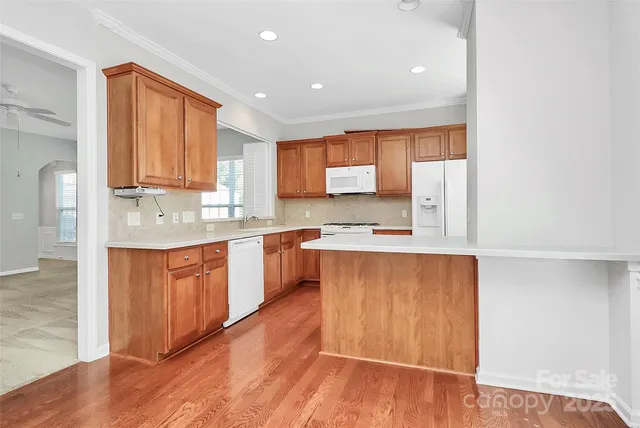 a kitchen with stainless steel appliances white cabinets and a refrigerator