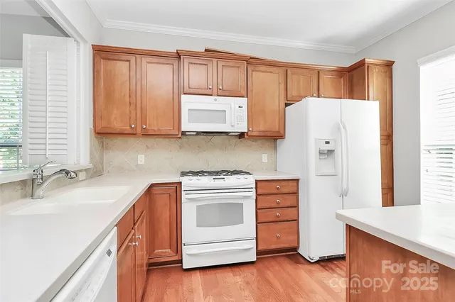 a large kitchen with stainless steel appliances kitchen island a large counter top and a wooden floors