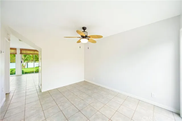 an empty room with wooden floor and a large window