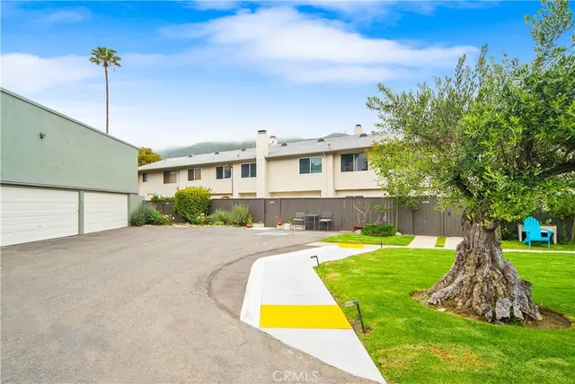 an aerial view of a swimming pool with a yard