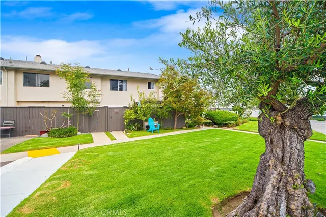 a view of a backyard with plants and lake view
