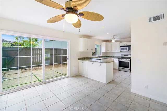 a kitchen with granite countertop a stove sink and microwave