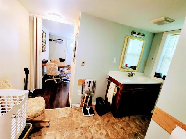 a bathroom with a sink mirror vanity and toilet