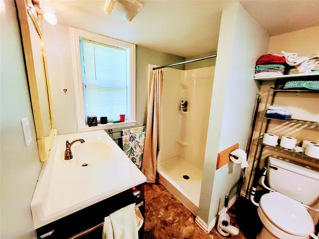 a bathroom with a sink toilet and shower