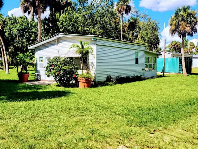 a view of a house with a yard and plants
